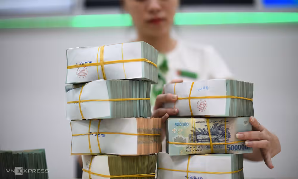 Nhân viên ngân hàng đang kiểm đếm tiền gửi tiết kiệm của khách hàng